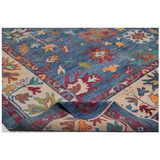 This stunningly beautiful traditional handwoven Turkish Oushak rug is a compelling work of art for anyone wanting a simple...