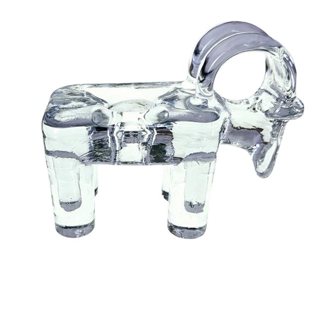 This Kosta Boda candle holder is a modern silhouette of a ram, with a distinctive longhorn silhouette. Crafted from glass...