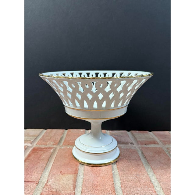 Vintage Italian white reticulated pedestal basket compote with gold accents. Lovely fruit bowl with classic style. Circa...