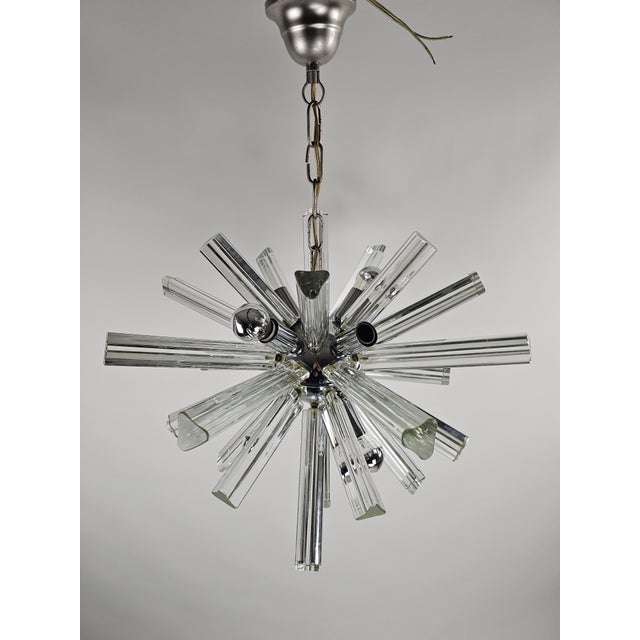 Italian Starburst Sputnik Chandelier in Chrome & Murano Glass, 1960s, in Very Good conditions. Designed 1960 to 1969 Up to...
