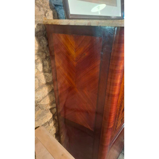 A very rare marquetry secretary desk, made in the early 20th century. It is richly decorated with marquetry scenes. It has...