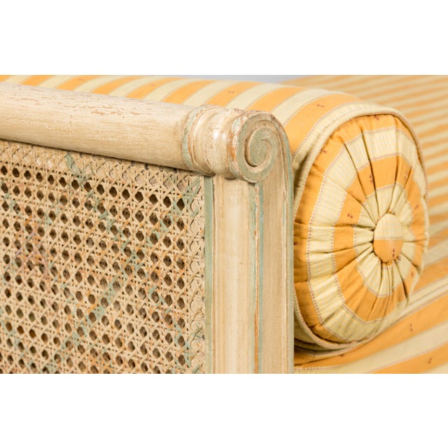 Sourced in Provence, France, this early 20th century French daybed is executed in the Louis XVI taste and showcases an...