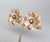 Circa late 1960s textured goldtone flower with single small clear round rhinestone in the center surrounded by small round...