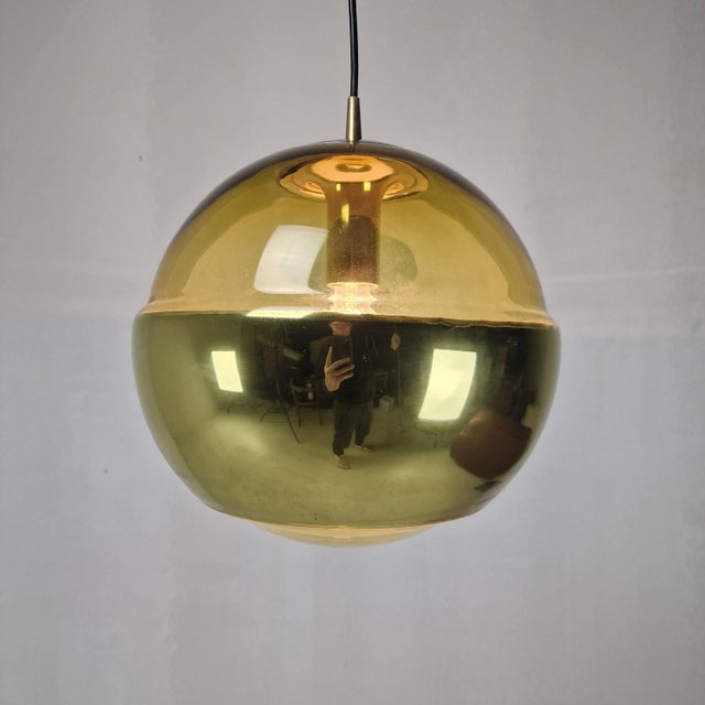 A striking single pendant light by renowned german manufacturer peill & putzler, crafted in the 1970s. The globe is made...