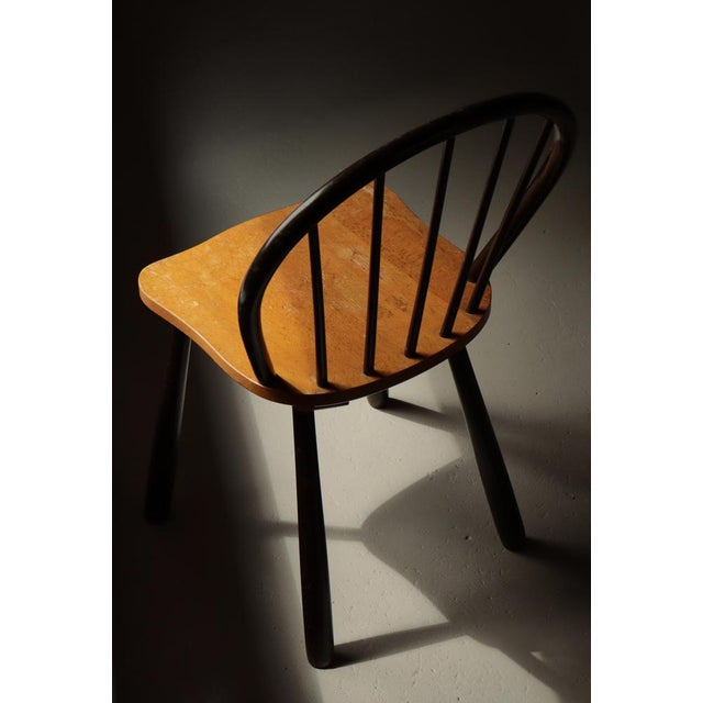 Elegant and sculptural Danish “Funkis” spindle-back chair model no. 4157 by renowned maker Fritz Hansen, produced in...