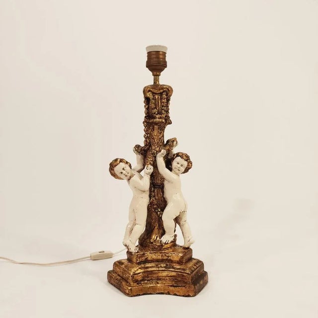 Table lamp or baroque -style desktop of the 50s. Body and polychrome plaster base and finished in gold bread, representing...