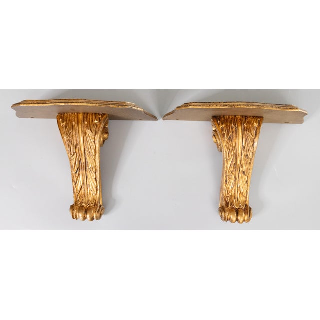 A lovely pair of vintage Mid-Century Italian Neoclassical style giltwood & gesso wall brackets shelves with hand carved...