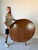 Elegant vintage English-style round dining table featuring a striking patchwork burl walnut veneer top, showcasing rich...