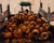 The painting depicts a vibrant heap of discarded pumpkins, their hollowed forms suggesting the end of a fruitful harvest....