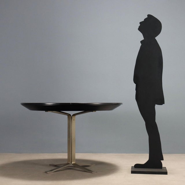 Table with extendable top, features a chromed metal base and the top is made of exotic wood veneer. Good condition. This...