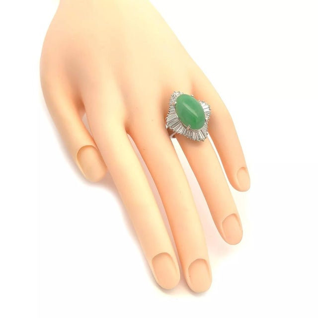 This is a stunning cocktail ring, crafted from platinum featuring the wave skirt ballerina design with sparkling baguette...