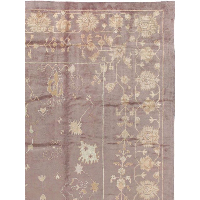 A mauve colored antique Turkish Oushak 12' x 15' large room size rug handmade during the early 20th century. Measures: 11'...