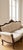 Vintage Victorian sofa and accent chair featuring ornate carved wood frame, camelback silhouette, and preserved floral...