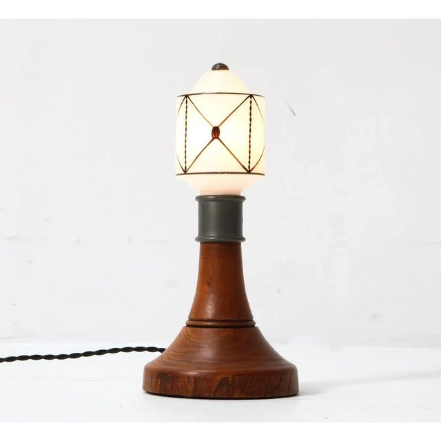 Wonderful and rare Arts & Crafts Art Nouveau table lamp. Striking Dutch design from the 1900s. Solid elm base with...