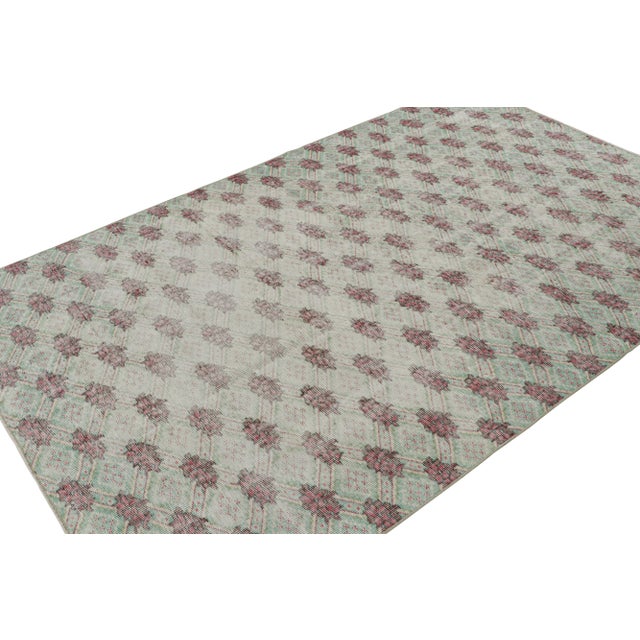 Hand Knotted in wool, this 5x8 vintage Zeki Múren rug originating from Turkey, circa 1960-1970, features geometric...