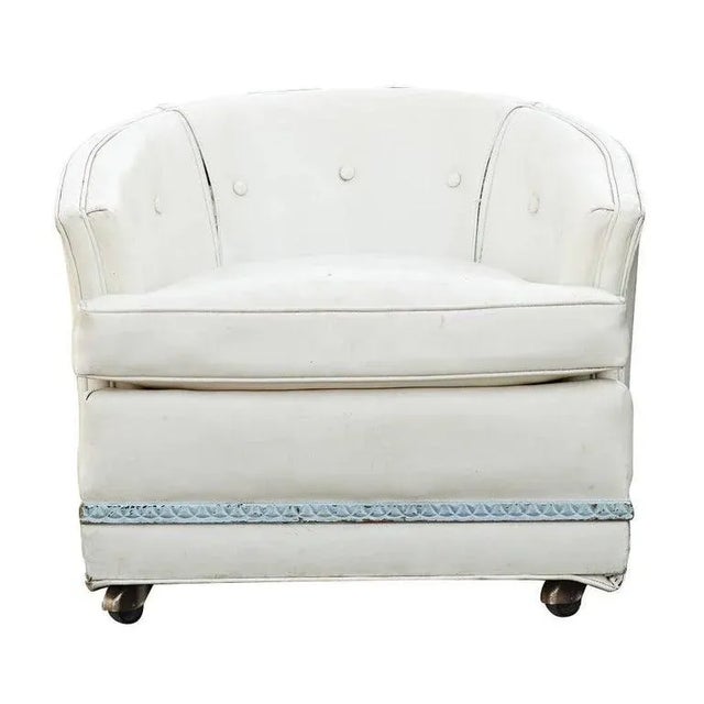 Pair of vintage midcentury lounge chairs by John Stuart Inc. Low and deep with white vinyl upholstery and casters....