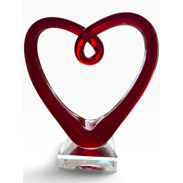 Striking vintage red art glass heart sculpture with a dramatic sculptural silhouette and rich translucent color. The hand-...
