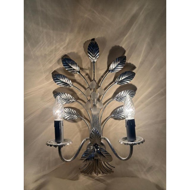 An exceptional pair of italian florentine wall lights, handcrafted in italy, most likely in the florence region during the...