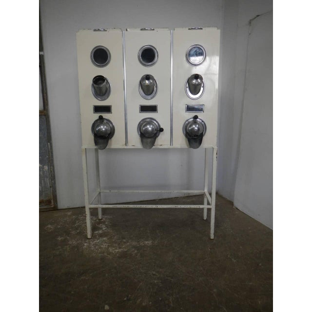 Metal container for dispensing coffee beans. with two measuring cups (the third is missing), three dispensers, three round...