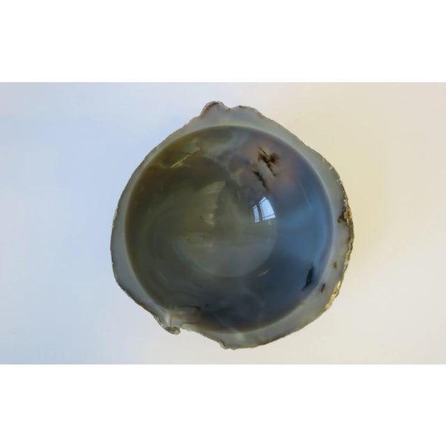 A unique onyx marble bowl in a blue grey hue. Raw exterior, and an interior that is polished smooth. Bowl measures: 3"...