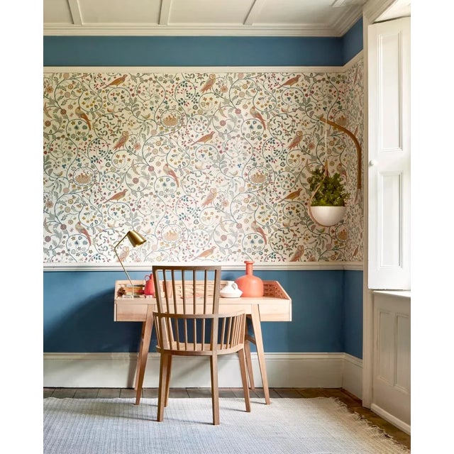 The distinctive owl in this cheerful Morris & Co. wallpaper of scrolling leaves and berries was inspired by an embroidered...
