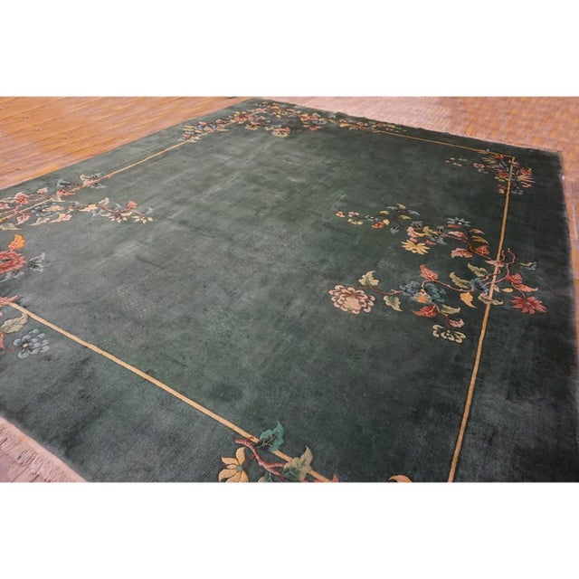 An authentic 1930s Chinese Art Deco wool carpet featuring a solid green field and matching green border. Hand-knotted with...