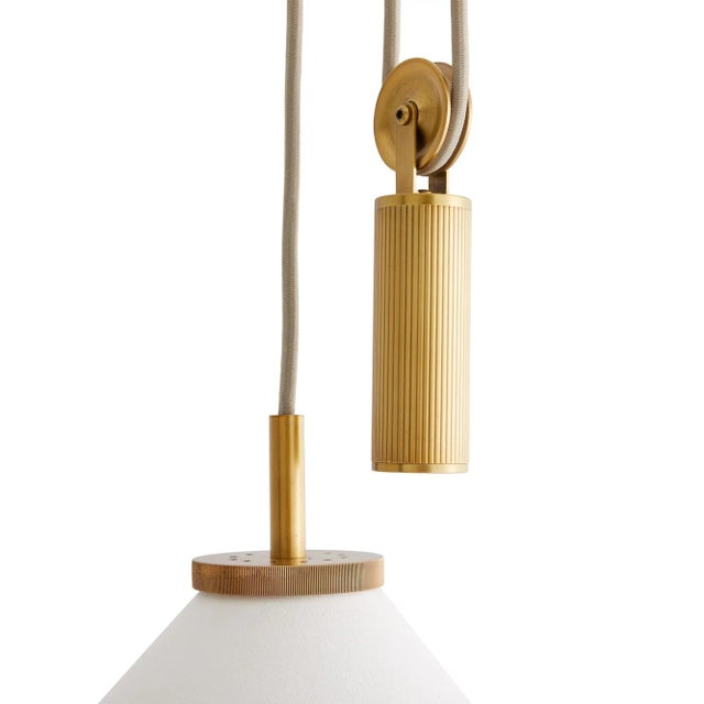 The Norfolk is a finely crafted counterweight pendant with a contemporary, clean-lined profile crafted with a white linen...