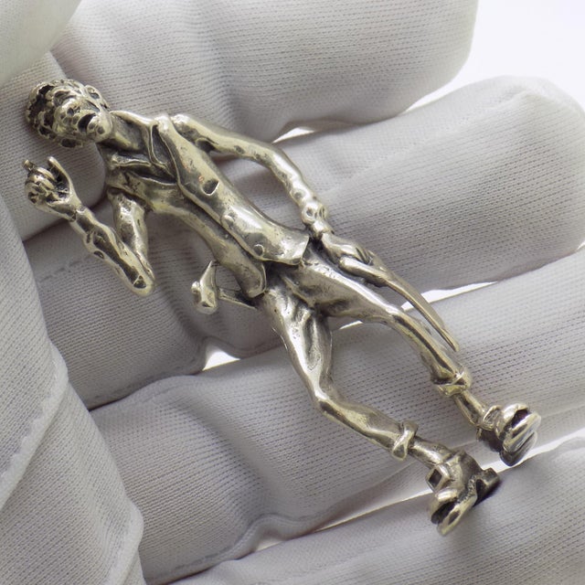 A charming tribute to manual craft and everyday life, this vintage solid silver figurine depicts a handyman equipped with...