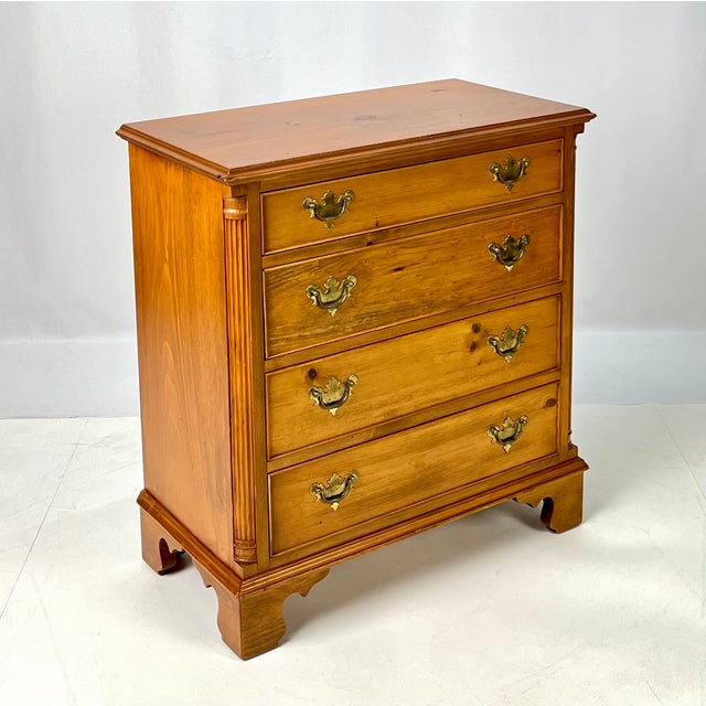 This Chippendale-style chest of drawers by Kittinger Furniture (Model #733) is crafted from knotty pine with a warm amber...