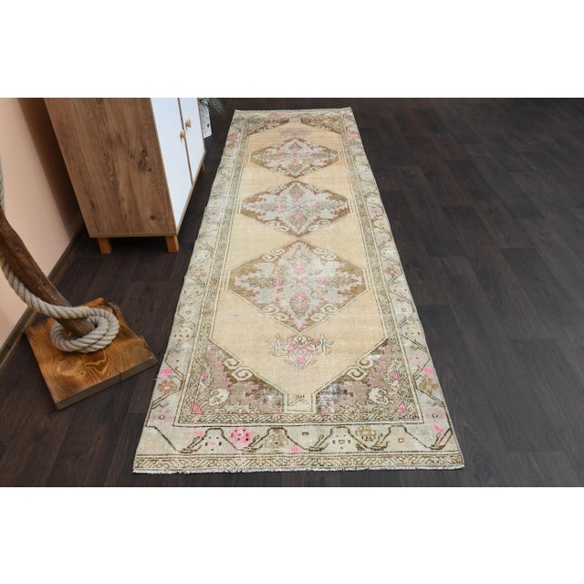 Vintage Turkish Hand-Knotted vintage rug is a semi- vintage runner rug.'70s Eastern region of Turkey's unique rug is...