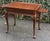 Beautifully crafted Ethan Allen tea table featuring a rich, warm wood finish and timeless Queen Anne styling. This elegant...