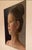 The painting captures a serene profile of a young woman, emphasizing her delicate features and thoughtful expression....