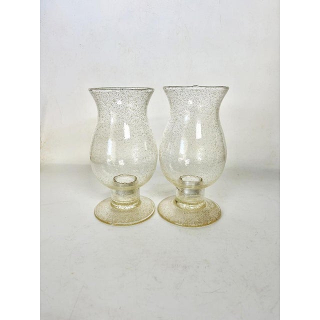 Pair of French candle holders from the 1970s, made of clear, bubbled glass. Each piece has a beautifully curved and...