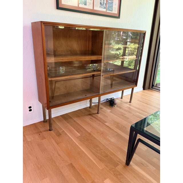 Mid Century Danish Glassfront Bookcase A narrow mid-century modern cabinet or bookcase with sliding glass door front and...