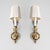 A pair of vintage French Provincial style wall sconces with polished brass design and candletick style light.
