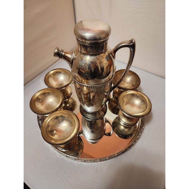 This Silverplated Art Deco Cocktail Shaker Set is an Art Deco bar cart show stopper. It is a "married" set that took a...