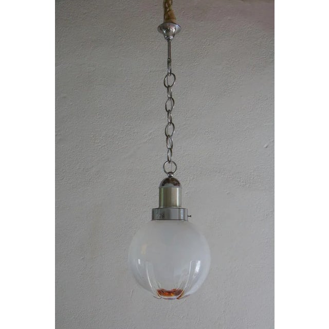Italian mid-century modern ball pendant lamp in smoked glass with a touch of orange, attributed to Mazzega, from the...