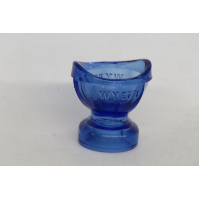 This incredible Glass Eye Cup is made of glass. This piece is a remarkable relic of the 1950s made of thick, quality blue...