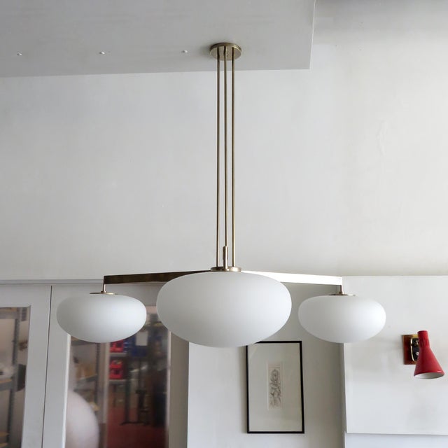 Stunning large-scale three-arm chandelier by Gallery L7, handcrafted and finished in Los Angeles from American brass with...