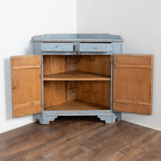 Low corner cabinet from Sweden with a (newer) blue painted finish softly scraped to reveal the natural pine below...