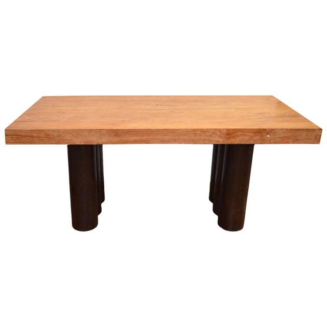 This four inch thick teak cerused top rests on a contrasting hollowed out coconut base stained espresso. Own an Andrianna...