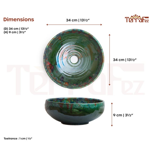 A handmade round bathroom sink, featuring reactive glaze in vibrant turquoise and teal tones with organic splashes of...