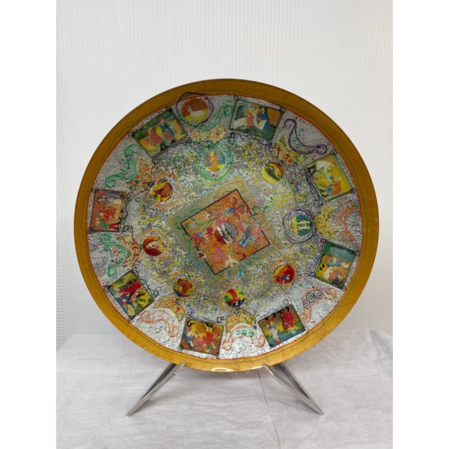 Design Plus Gallery presents a Glass Plate with Medieval Scenes + Stainless Steel Stand. The plate has a golden rim with...