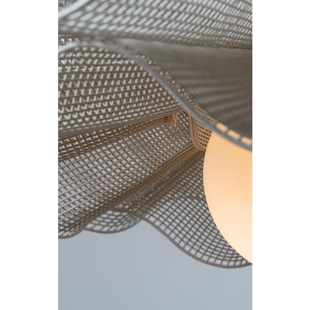 The Wiggle Pendant Light by Schema for Oggetti takes inspiration from playfulness, natural movement, and feather-like...