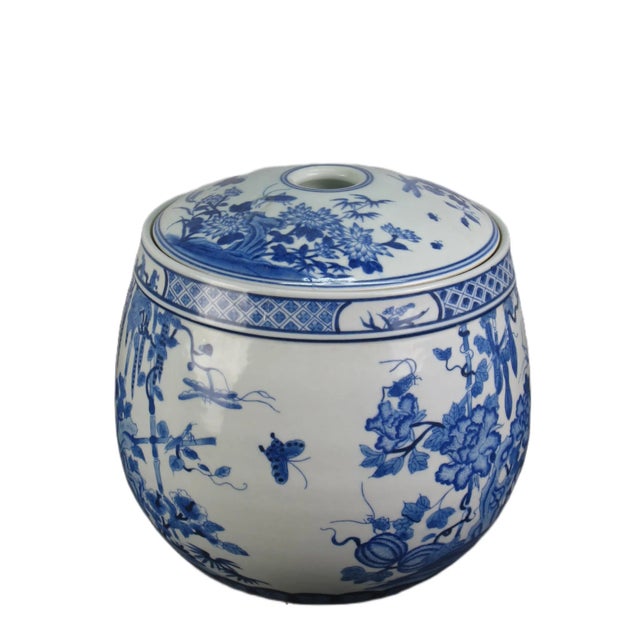 This gorgeous blue and white porcelain jar is adorned with beautifully hand painted plants, flowers, and butterflies....