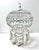 Ornate Hollywood Regency birdcage sculpture featuring intricate whitewashed metal scrollwork accented with green jewel...