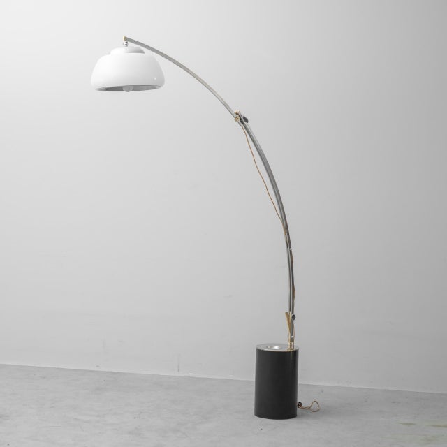Floor lamp made in the 1980s. Metal frame. Arm adjustable in height and/or length. Features dual lighting. One inside the...
