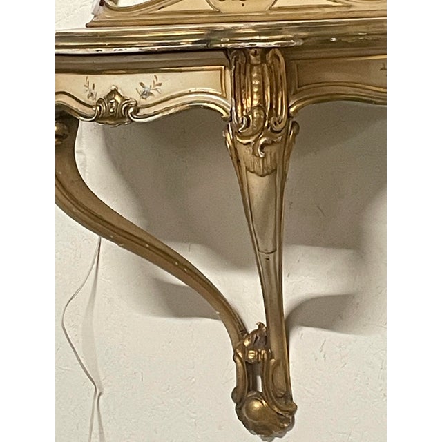 Pair of wall-mounted console tables with matching mirrors and integrated sconces, made in the 1940s in the Baroque/Louis...