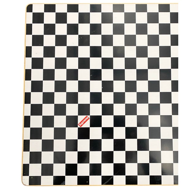 A limited edition Alvar Aalto Bench 153 in Birch with custom checkerboard top and Supreme logo.