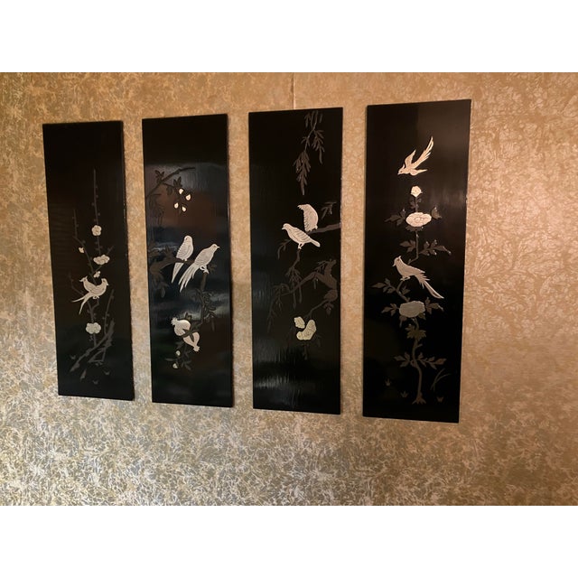 Set of four (4) handmade vintage Oriental-themed black lacquer wall art panels featuring intricate designs and...